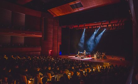 Performers on stage in front of a crowd