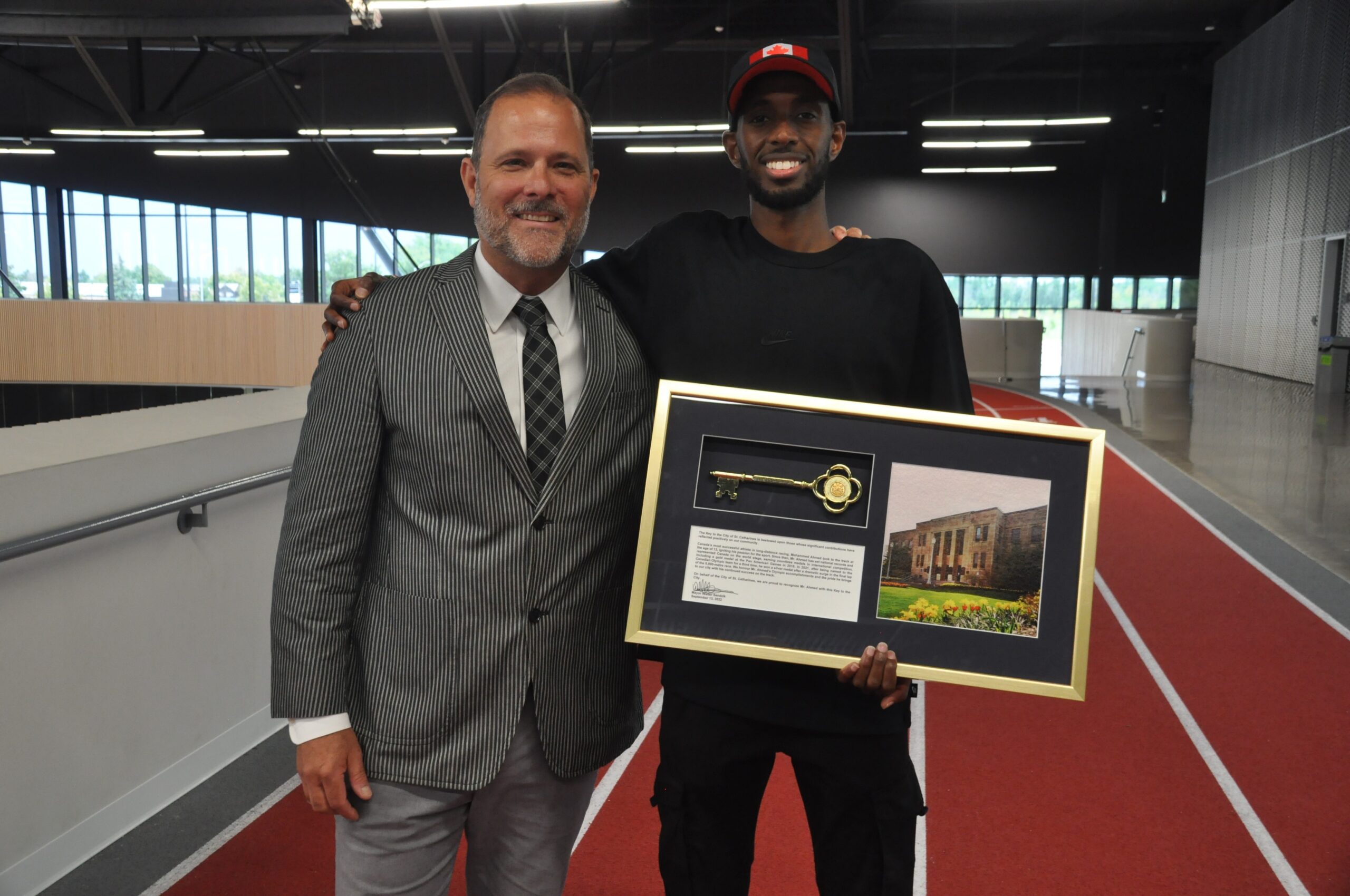 Mayor Walter Sendzik with Olympian Mohammed Ahmed, who is holding the key to the City