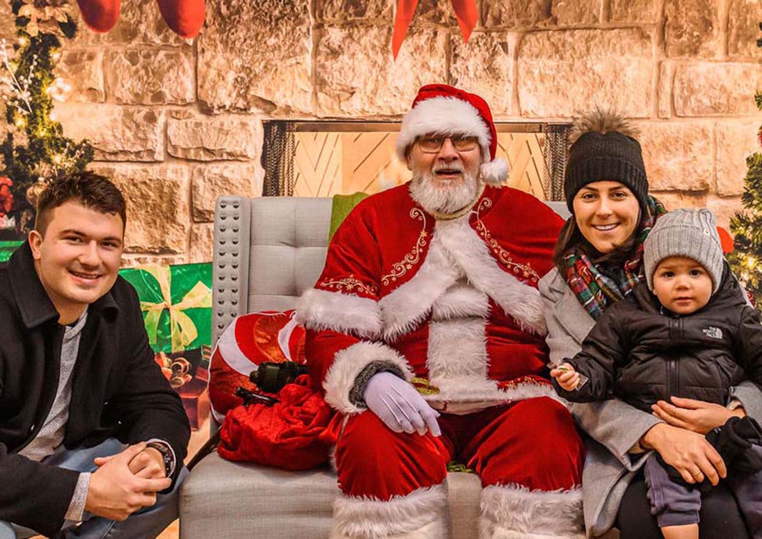 A family sits for their photo with Santa in December 2024 at the St. Catharines Farmers Market
