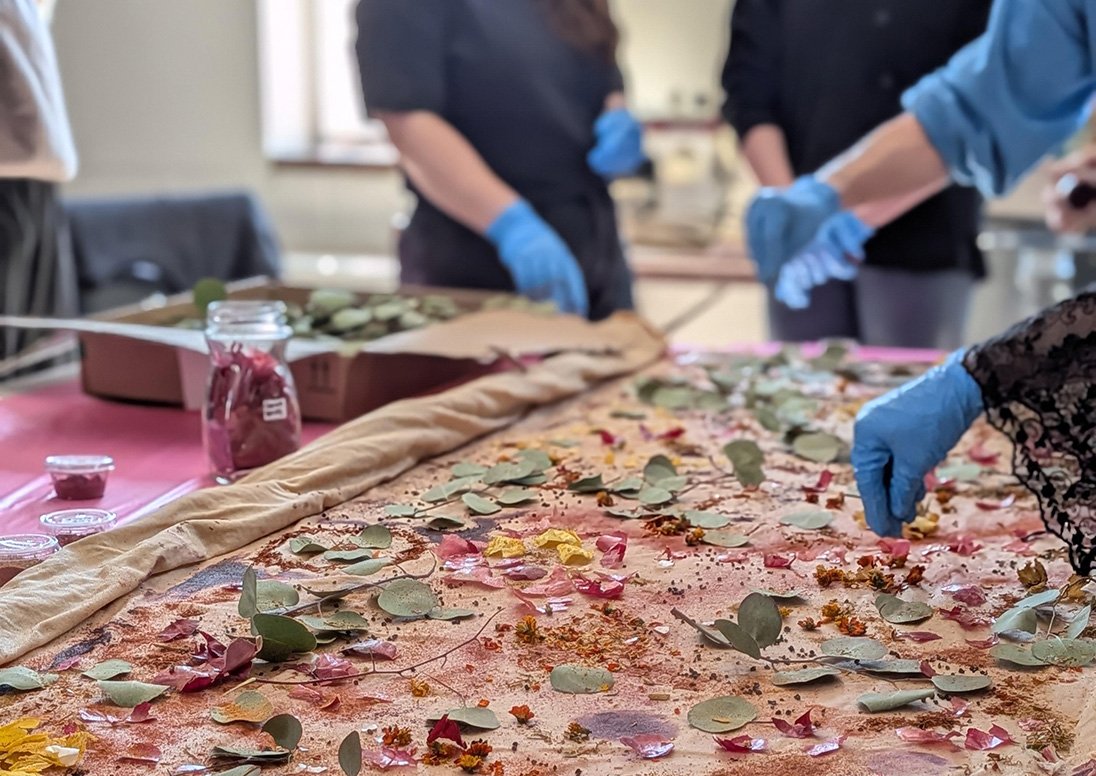 Photo of an Eco Dying Textiles Workshop for the 2026 Pride Art Exhibition Call to Artists shot by Jess Max.