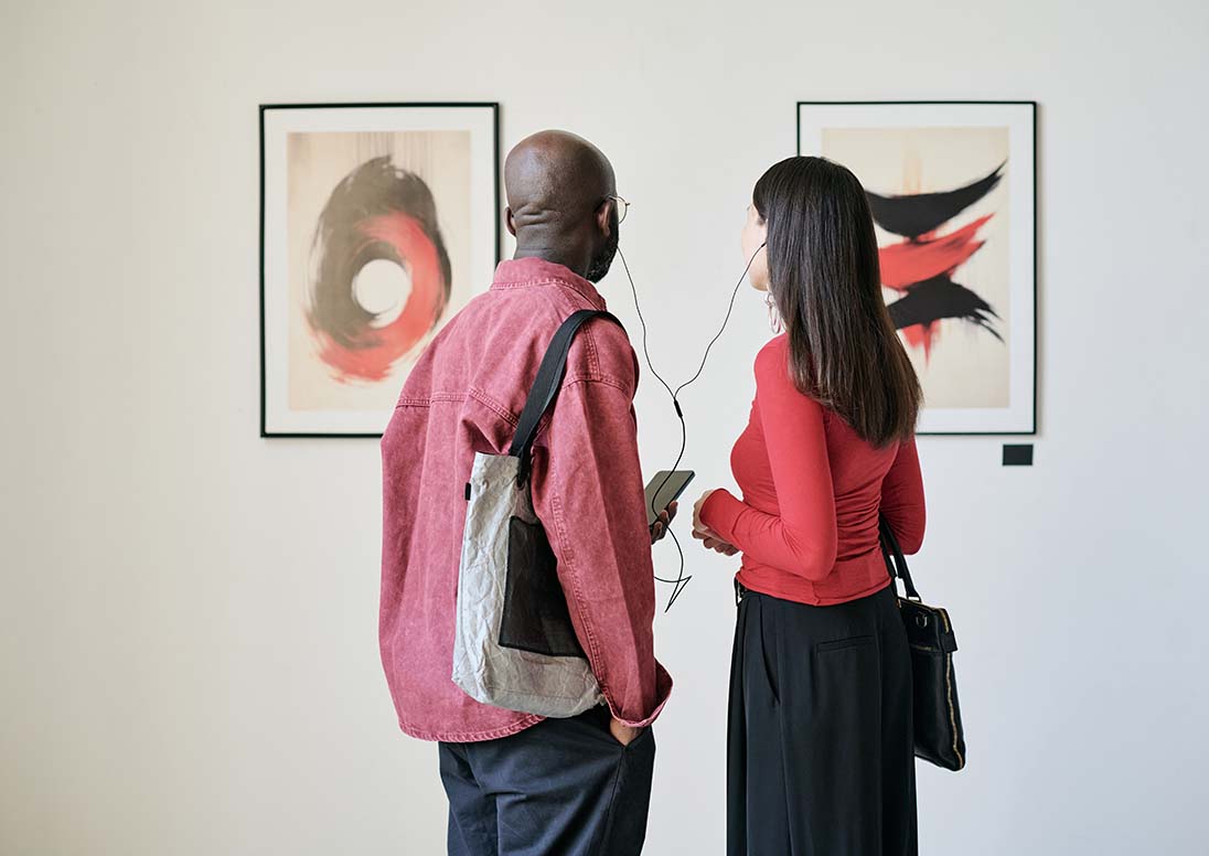 A man and woman looking at an art exhibit. Not the "Layers" annual juried art exhibition.