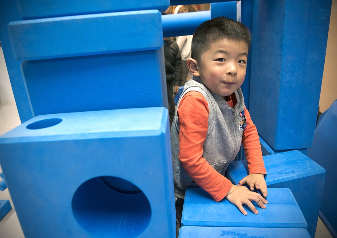 A child plays with the City's Big Blue Blocks tactile learning and play environment