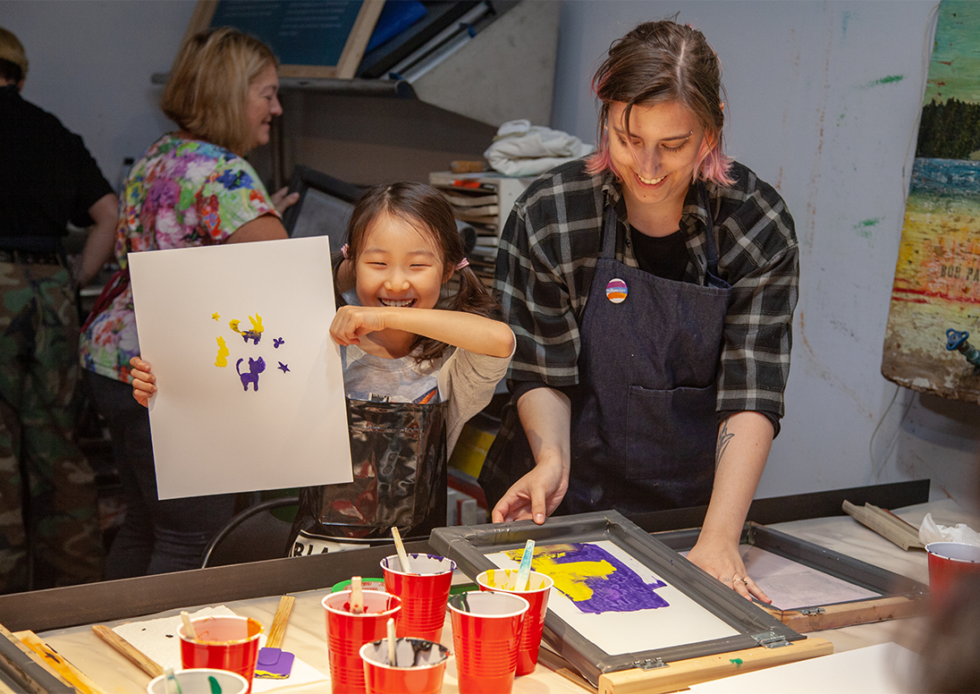 A child displaying a painting during a Culture Days workshop