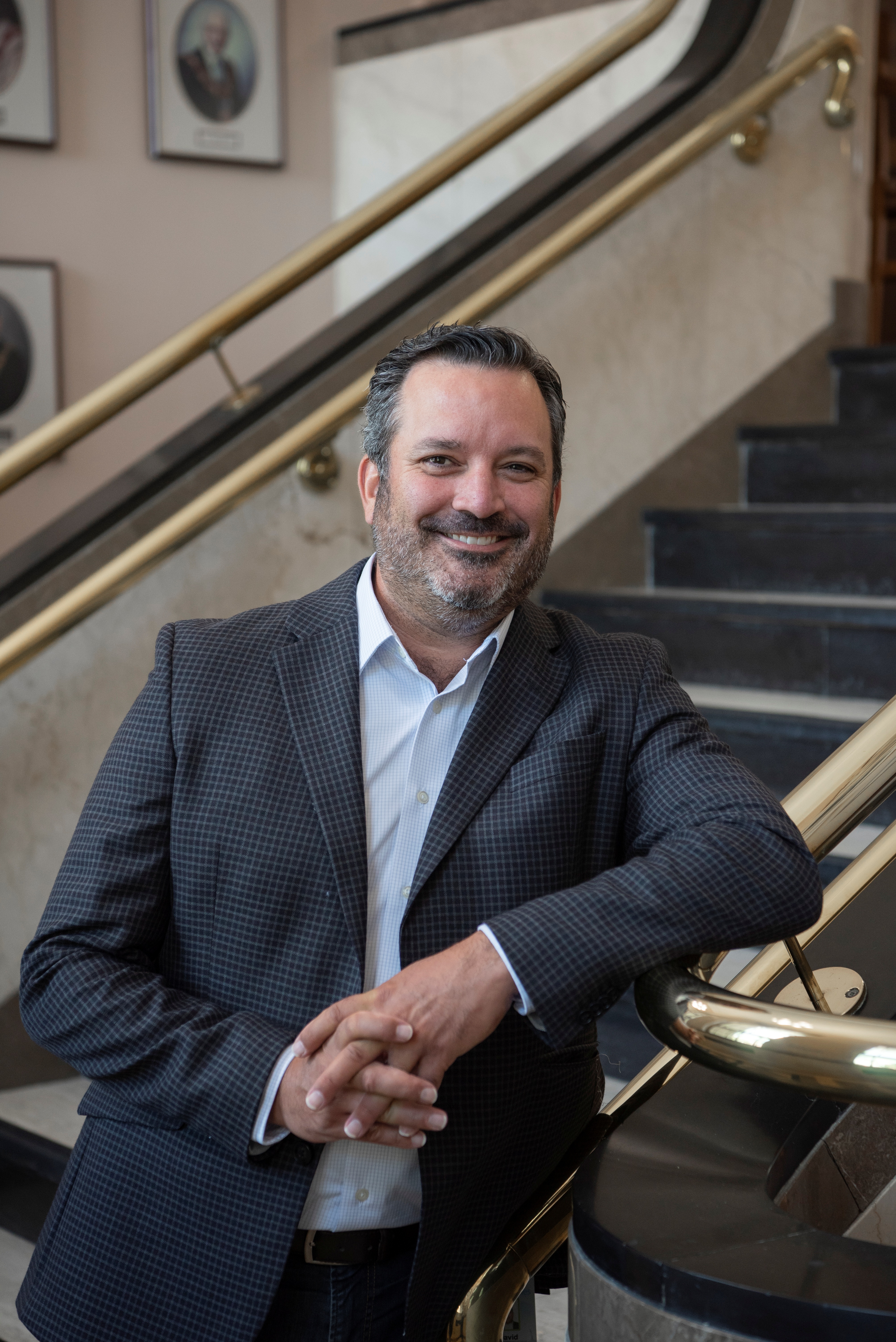 A photo of CAO David Oakes standing by a set of stairs