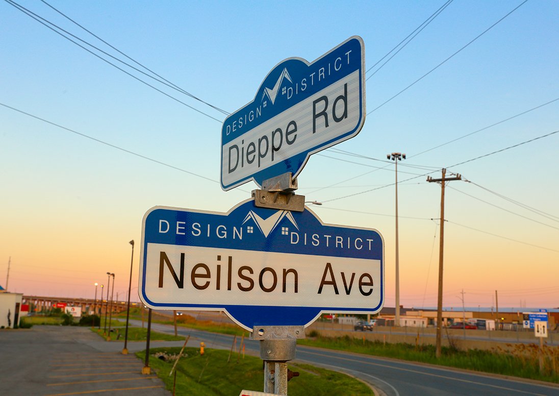 Blue and white street signs marking a design district