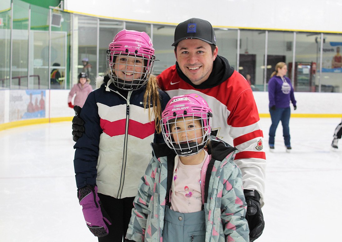 A dad and his two daughters skate at Seymour-Hannah Sports and Entertainment Centre.