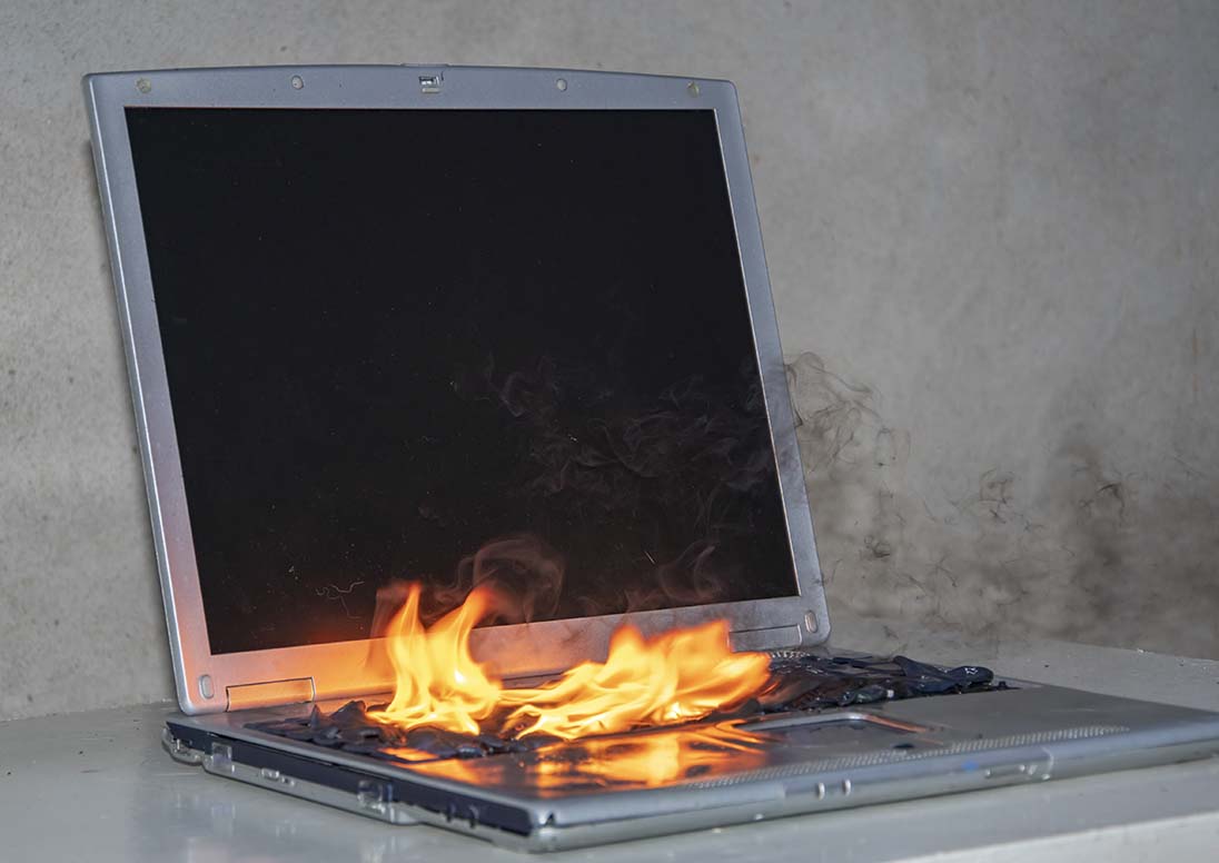 A laptop on fire after its lithium-ion battery ignited.