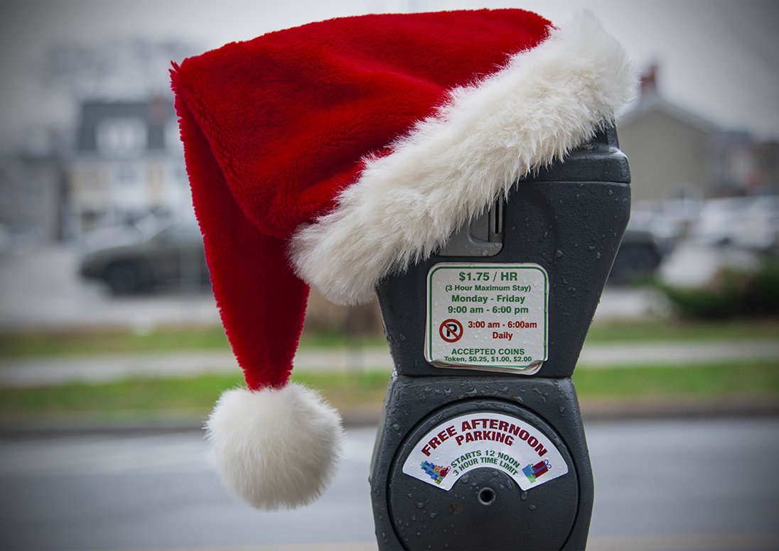 Parking meter with a Santa hat on it