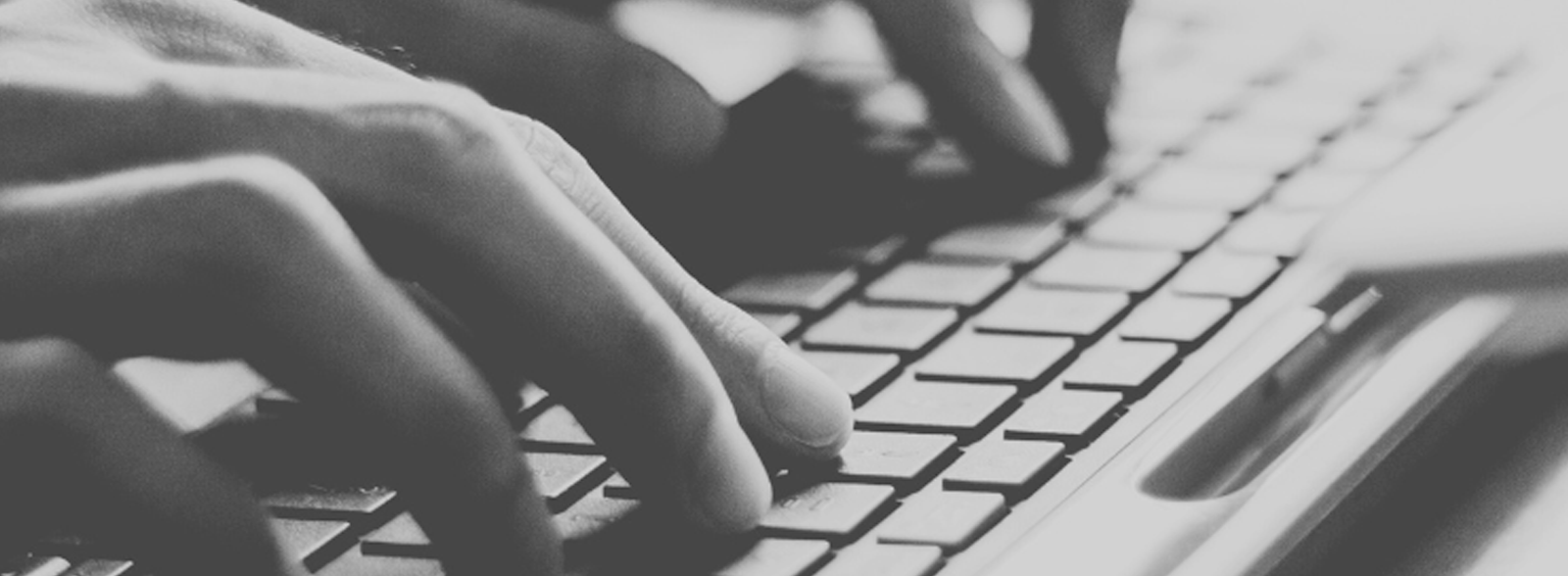 Fingers type on a computer keyboard