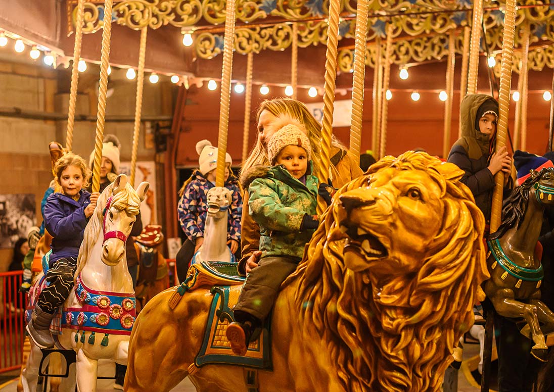 Children ride the Lakeside Park Carousel during the 2024 Let It Glow opening night.