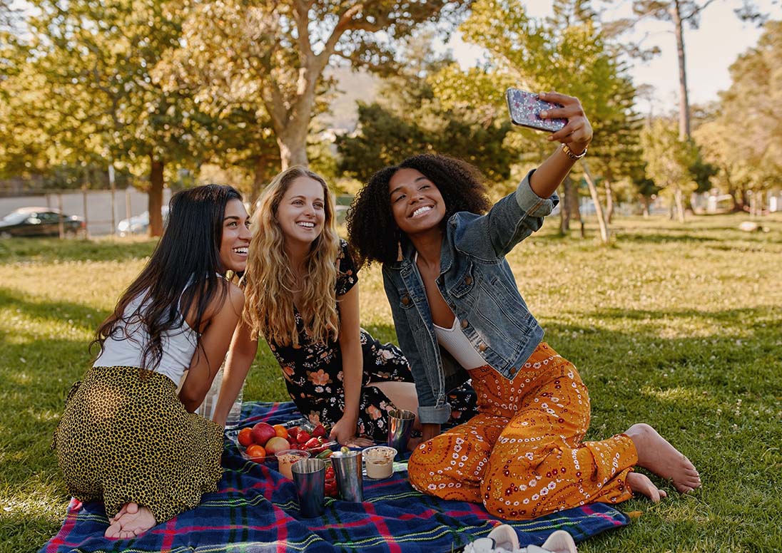 Young women picnicking in a park.