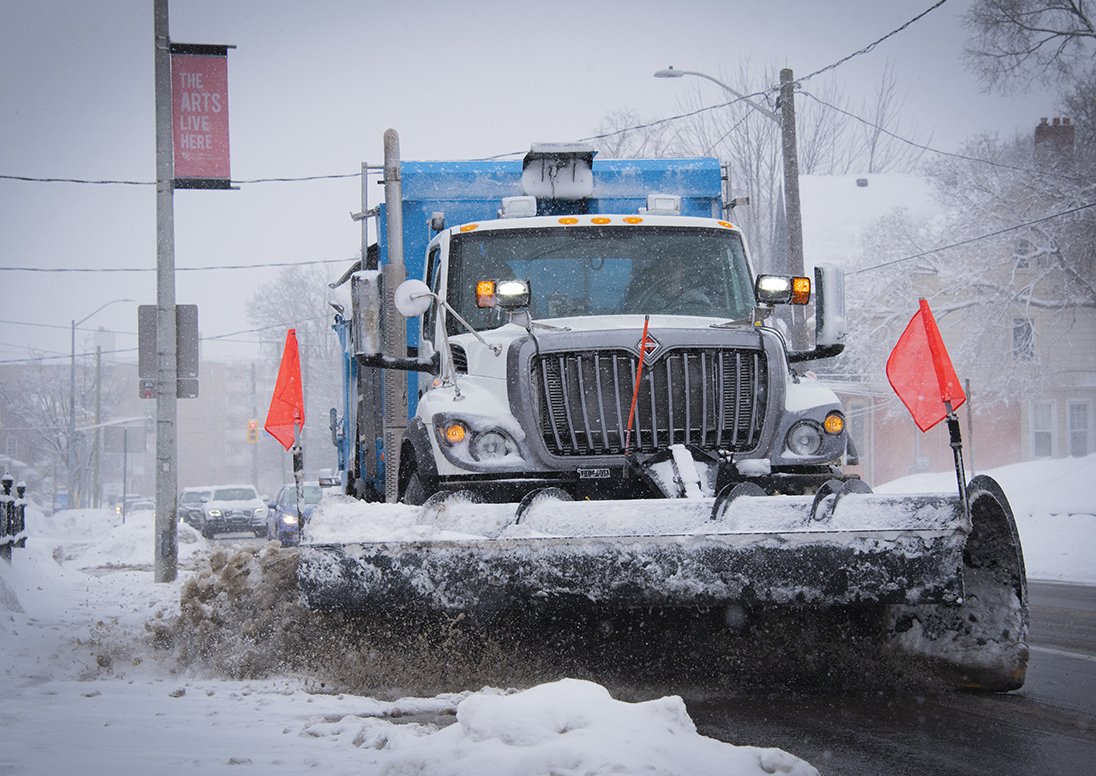 A snow plow clears snow