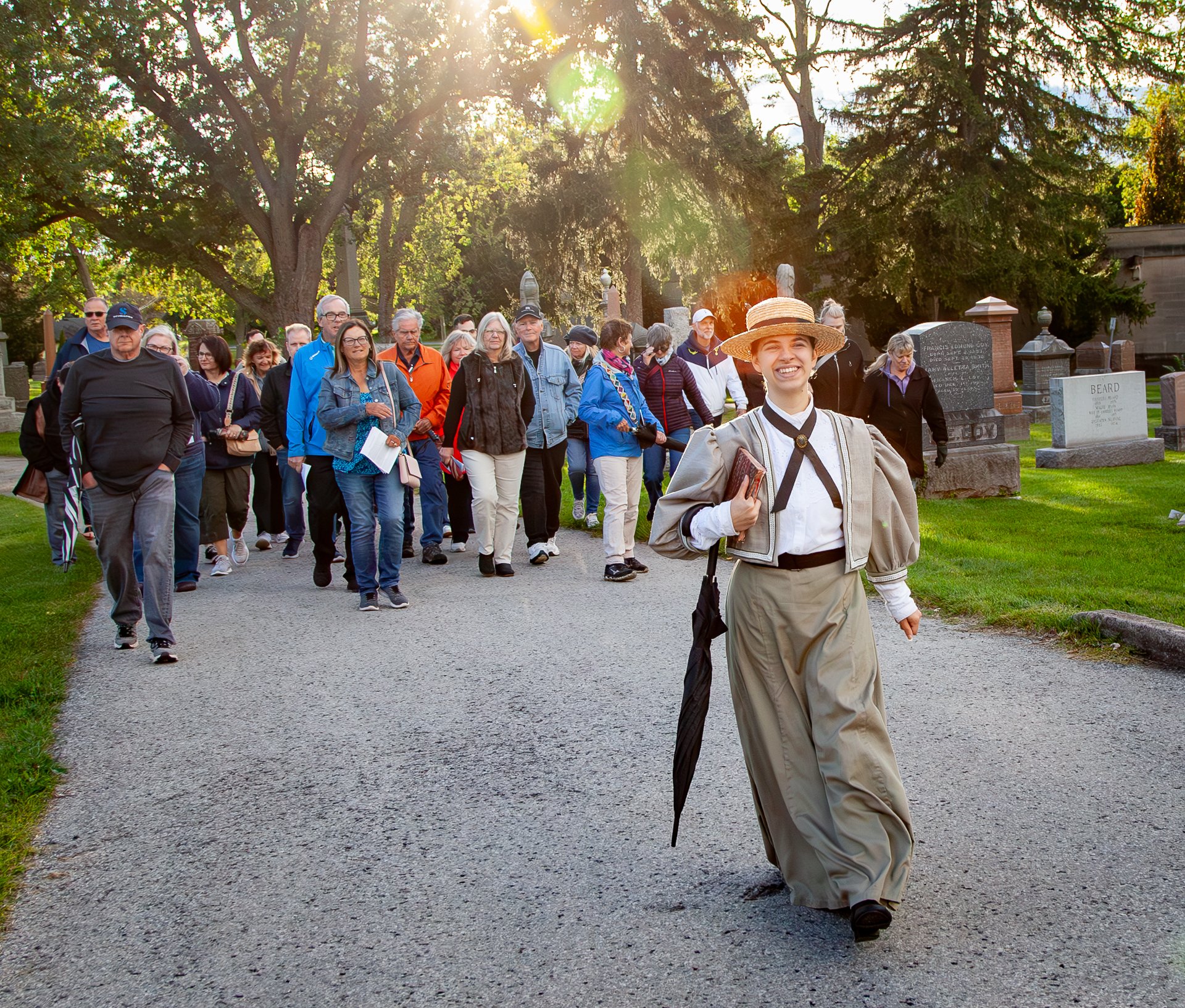 A costumed actor leads a group on a guided spirit walk tour