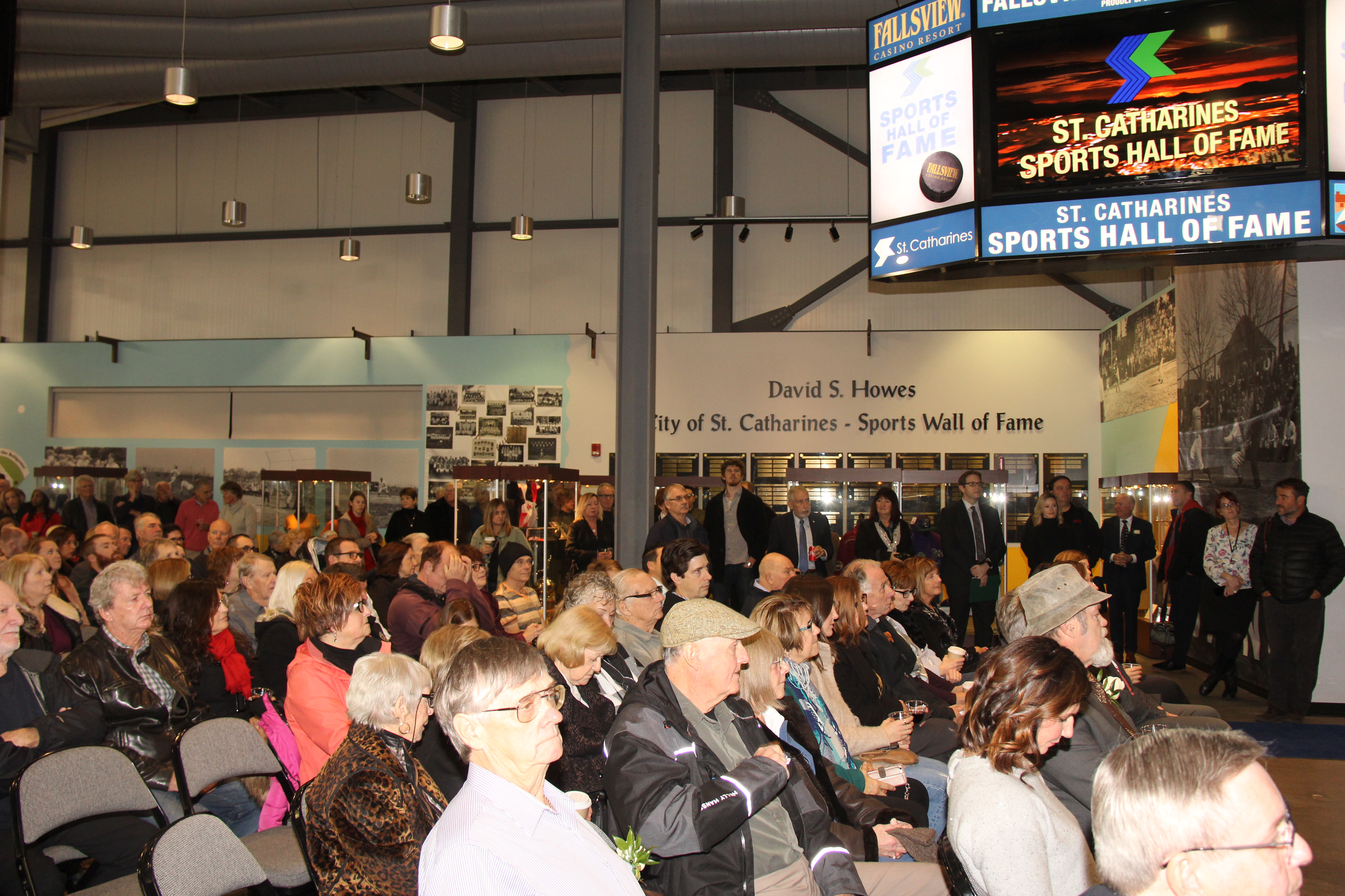 Individuals sitting in chairs at Meridian Centre during an induction ceremony for the St. Catharines Sports Hall of Fame
