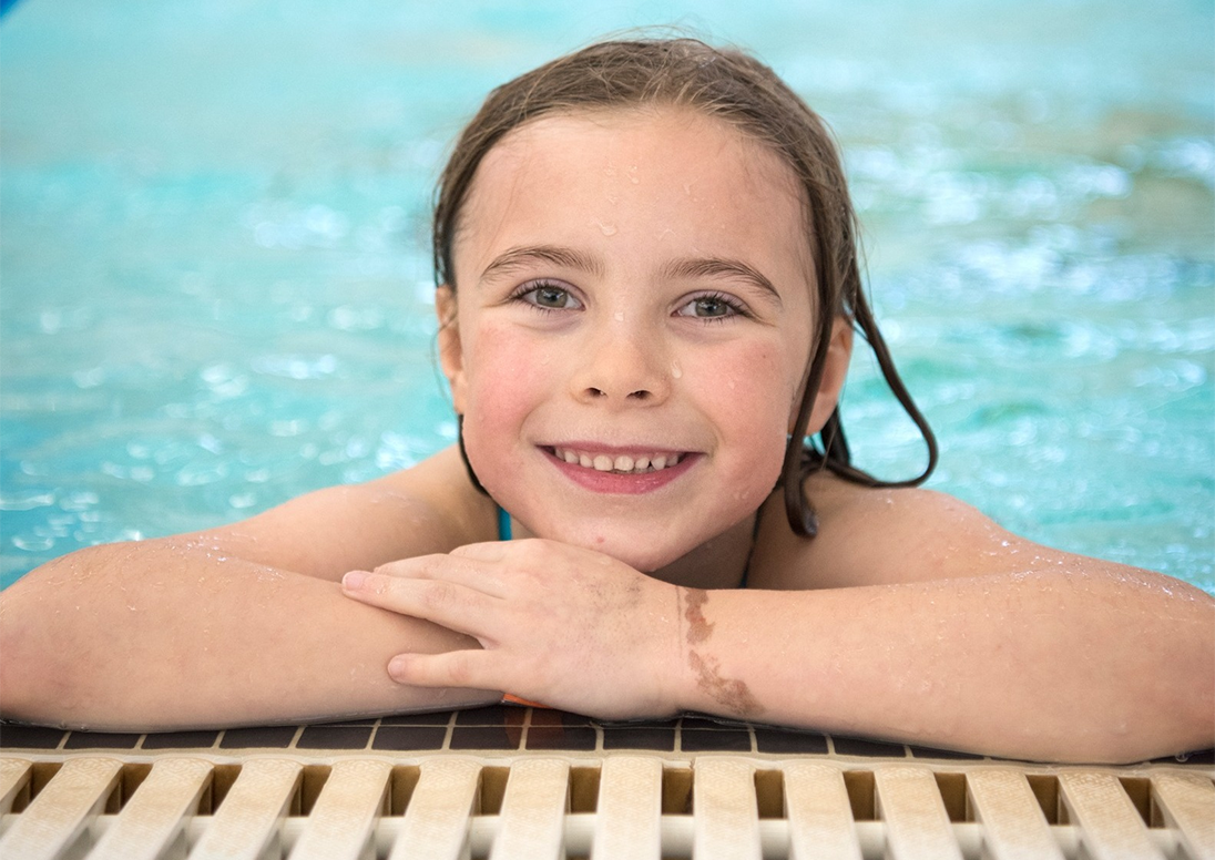 child at the end of a swimming pool