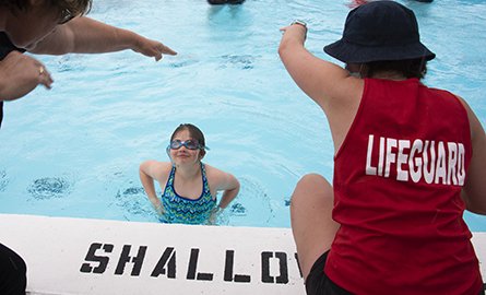 Girl receiving swimming instruction in a pool