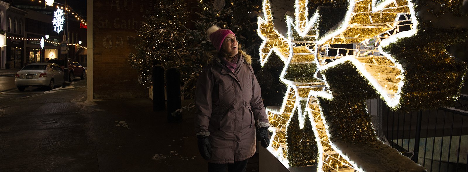 woman looking at illuminated snowflake