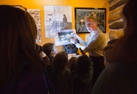 A volunteer leads a flash-light tour of the museum galleries