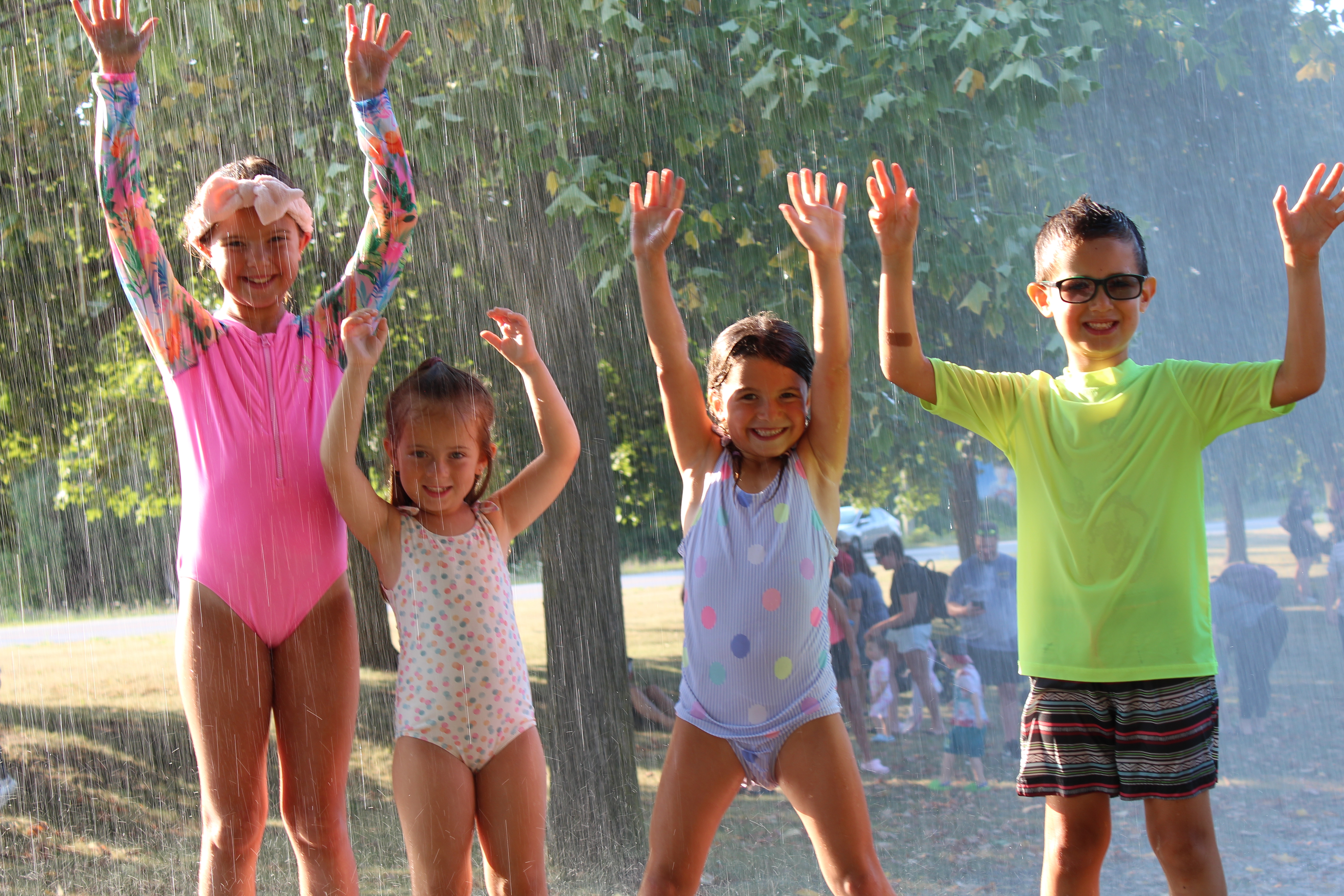 Kids celebrate Hot Summer Nights in the Fire Services Sprinkler Hose